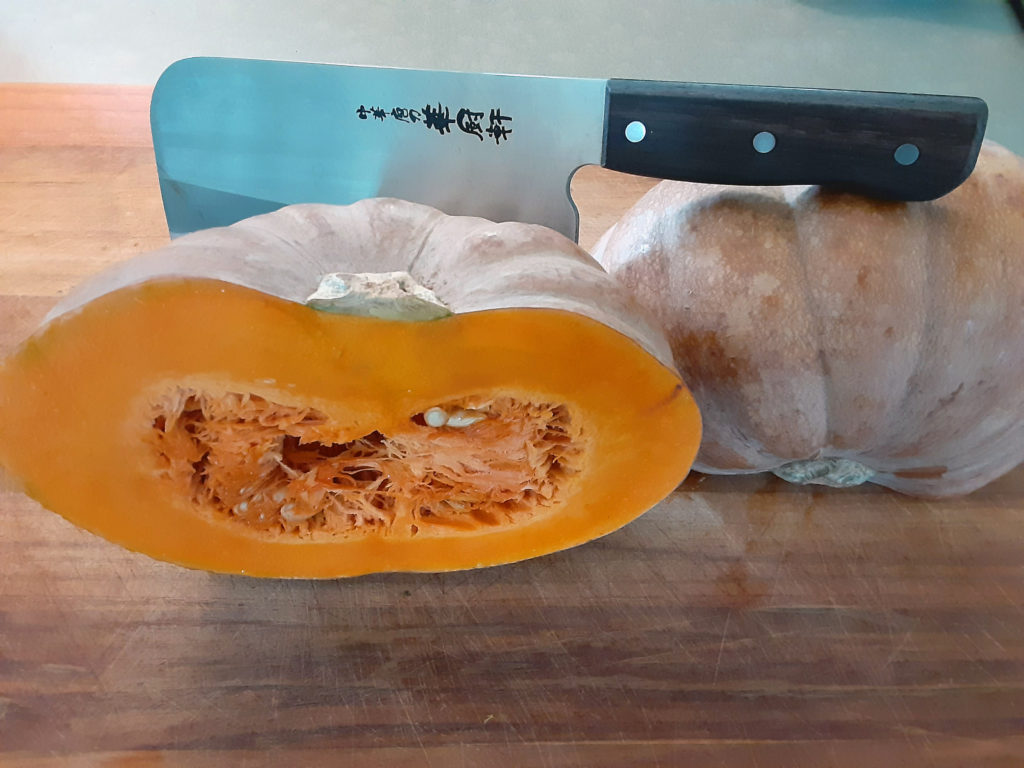 If you have a strong, sharp cleaver, it's less dangerous to cut a hard winter squash right down the middle. 