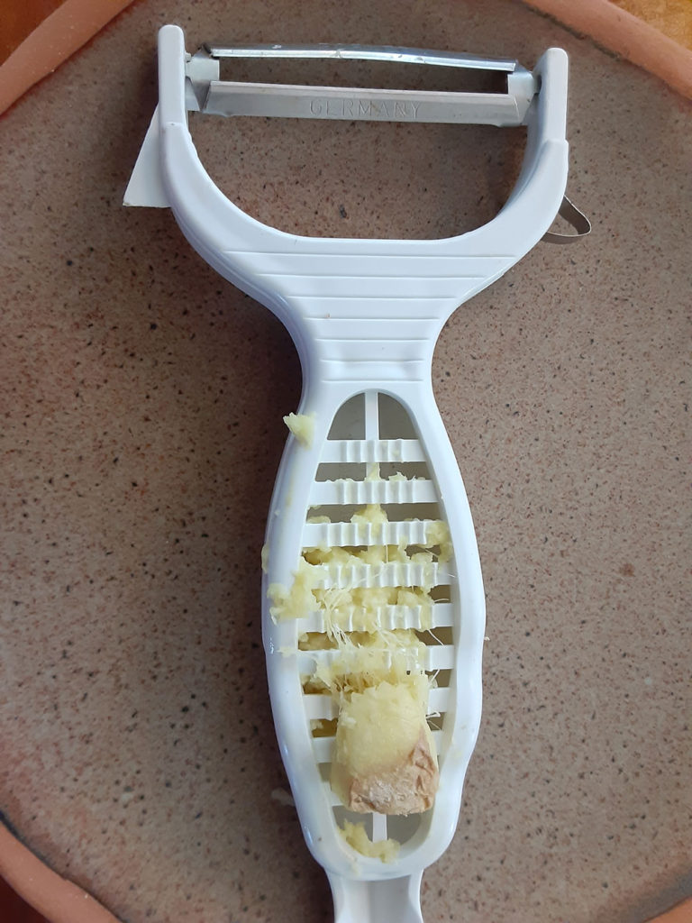 A Borner 6-in-1 prep tool shown grating fresh ginger.